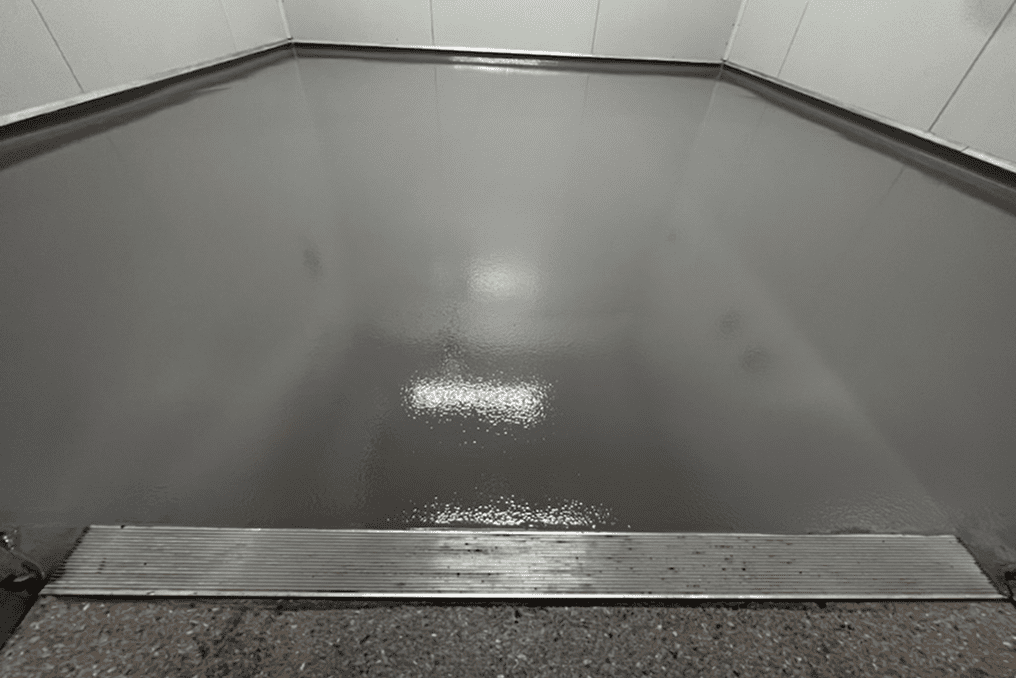 Shiny gray floor with metal threshold.